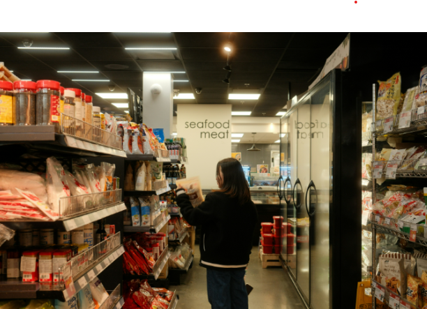 person browsing powdered broth products in grocery store aisle